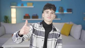 Handsome young male looking at camera expressing satisfaction. Happy and cheerful young man looking at camera expressing happiness. video