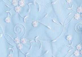 Delicate blue textile background with white colors. lace background. photo