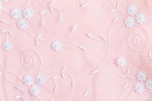 pastel background with white embroidered colors. delicate background texture. festive , wedding background. cloth. photo