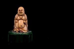 Buddha statue isolated on black background photo