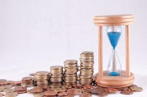 Hourglass and coins photo