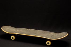 Skateboard on black background photo