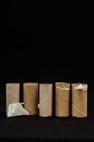 Cardboard rolls on black background photo