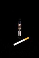 Electronic cigarette on black background photo