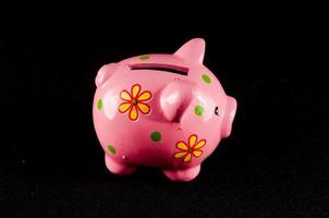 Piggy bank on black background photo