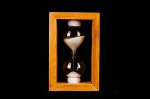 Hourglass on dark background photo