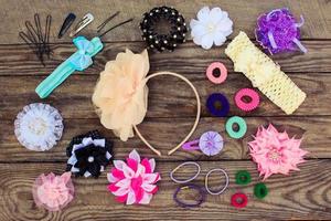 Different hair clips on wooden background photo