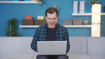 Man talking on facetime call from laptop. Man starting a facetime conversation by greeting. Video chat, get online support.
