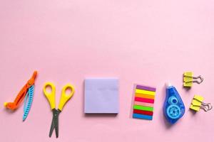 Back to school background. School accessories on a pink background. photo