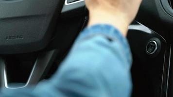 Close up of male finger pressing an engine start stop button in car video