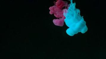 Color drop underwater creating a silk drapery. Ink swirling underwater. video