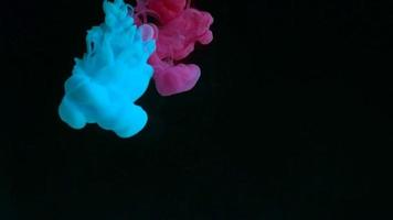 Color drop underwater creating a silk drapery. Ink swirling underwater. video