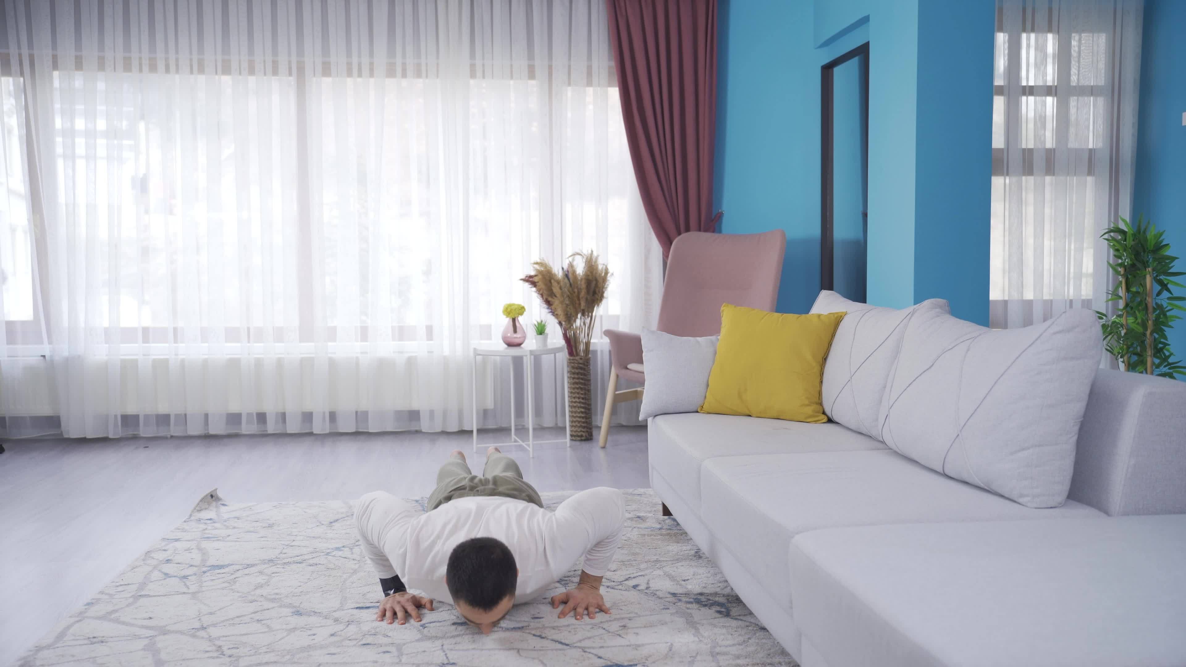 Young Man With Fit Body Doing Burpee To Build Muscles At Home Young young-man-with-fit-body-doing-burpee-to-build-muscles-at-home-young