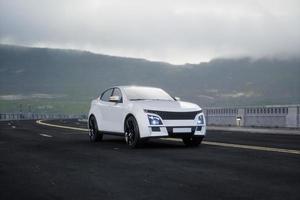 Generic and brandless SUV car on the road with mountain, 3d render photo