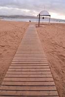 Wooden path on the beach photo