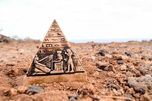 Miniature pyramide on the ground photo