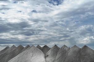 Cervia, Ravenna province, Italy September 08, 2022. Cervia is famous for its sweet, naturally produced salt. Here you represent mountains of salt harvested and ready for processing. photo