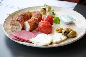salami sausage , olive and bread on a plate photo
