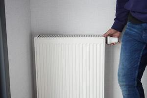 heating radiator under window in the room photo