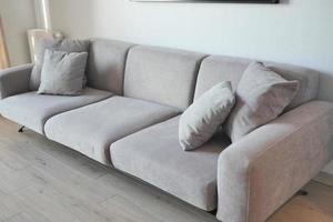 Grey couch in the extra living room loft with pillows photo