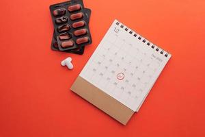 top view of medical pills and calendar , photo