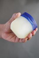 Close up of man hand using petroleum jelly photo