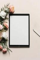 Flat lay digital tablet mockup with rose flowers, created with photo