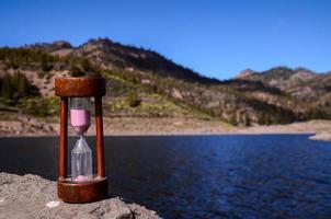 Hourglass on a rock photo