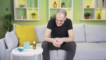 Crying man who does not want to use drugs. Because the man looking at the medicine does not want to use it, he hits it with his hand and cries. video