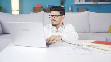 College student working on laptop and taking notes video