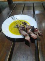 klatak satay made from young goat meat, served with yellow curry soup photo