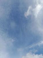 Beautiful white clouds on deep blue sky background. Large bright soft fluffy clouds are cover the entire blue sky. photo