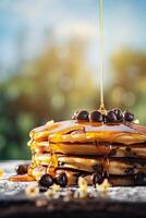 Syrup is poured down and chocolate chips are on top tall stack of golden pancakes layered on a plate with melted butter and syrup dripping down the sides of the stack. . photo