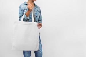 hipter woman holding eco fabric bag isolate on white background photo