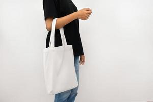 young woman holding eco cotton bag isolate on white background photo