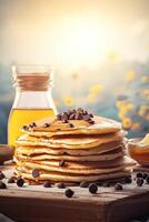 Syrup is poured down and chocolate chips are on top tall stack of golden pancakes layered on a plate with melted butter and syrup dripping down the sides of the stack. . photo