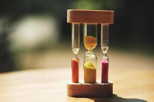 hourglass on table  and sunset photo