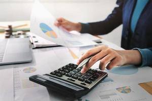 Business woman working in finance and accounting Analyze financial budget in the office photo