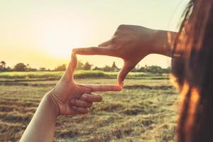 close up woman make hand framing gesture distant view. business concept photo