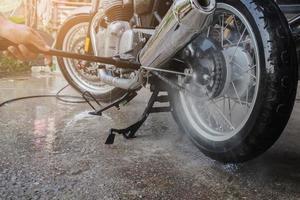 people wash cleaning motorcycle at home photo