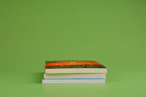 Books. Stack of books stacked on light green background. Reading. Reading concept. and collection of books photo
