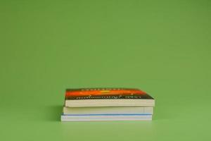 Books. Stack of books stacked on light green background. Reading. Reading concept. and collection of books photo