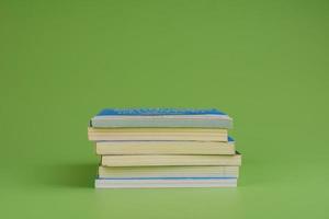 Books. Stack of books stacked on light green background. Reading. Reading concept. and collection of books photo