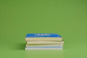 Books. Stack of books stacked on light green background. Reading. Reading concept. and collection of books photo