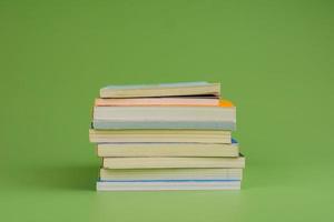 Books. Stack of books stacked on light green background. Reading. Reading concept. and collection of books photo