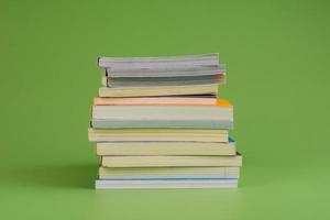 Books. Stack of books stacked on light green background. Reading. Reading concept. and collection of books photo