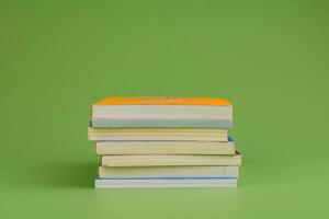 Books. Stack of books stacked on light green background. Reading. Reading concept. and collection of books photo