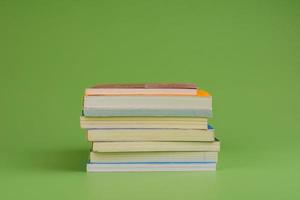 Books. Stack of books stacked on light green background. Reading. Reading concept. and collection of books photo