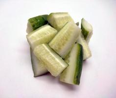 Cubed cucumber slices isolated in white background photo