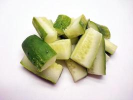 Cubed cucumber slices isolated in white background photo